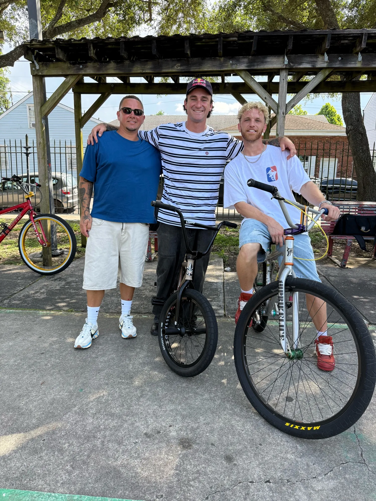 Riders with a bike displaying the 1UPBIKELIFE name on the fork
