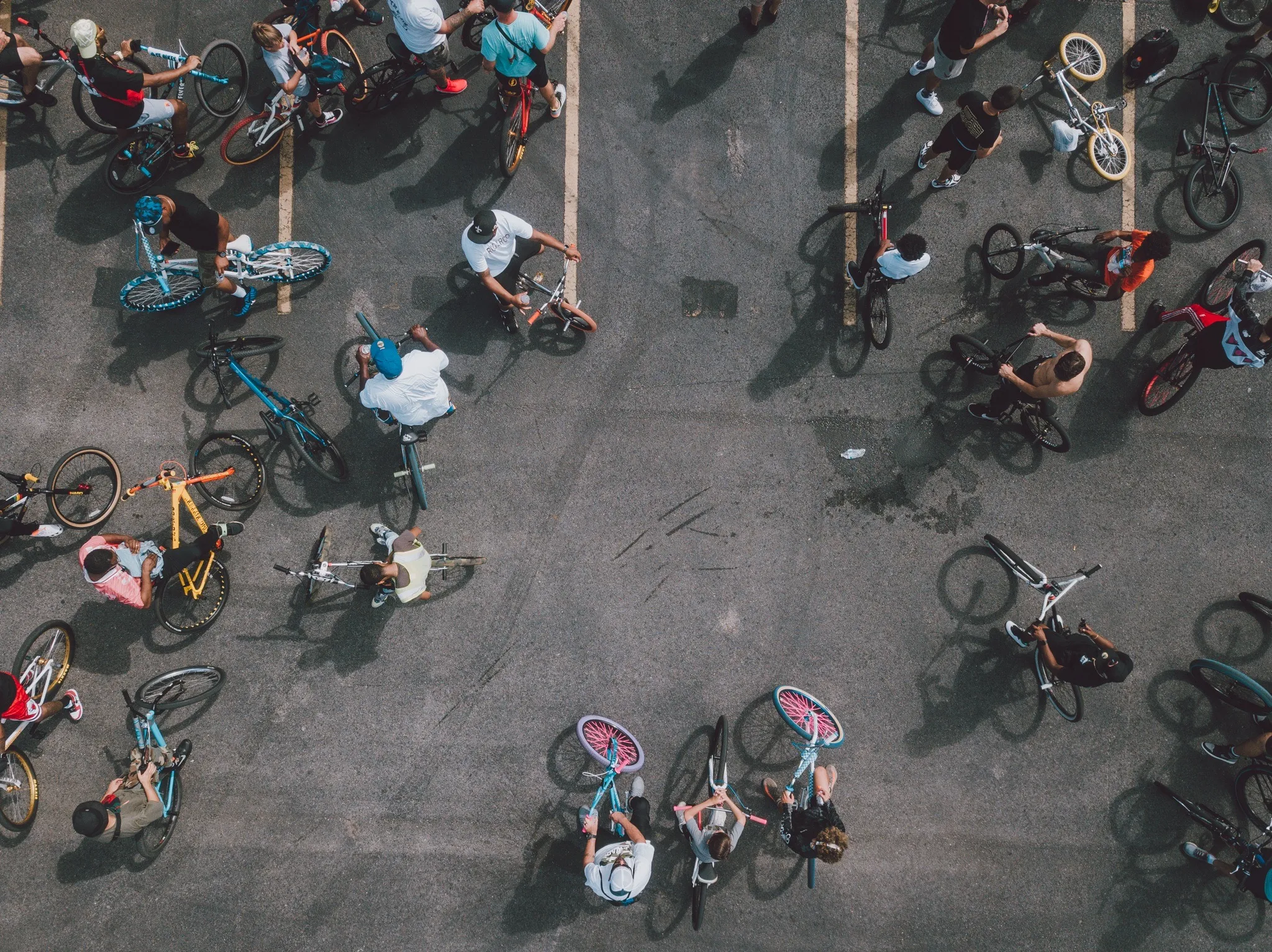 Aerial view of riders gathered in a parking lot before a ride